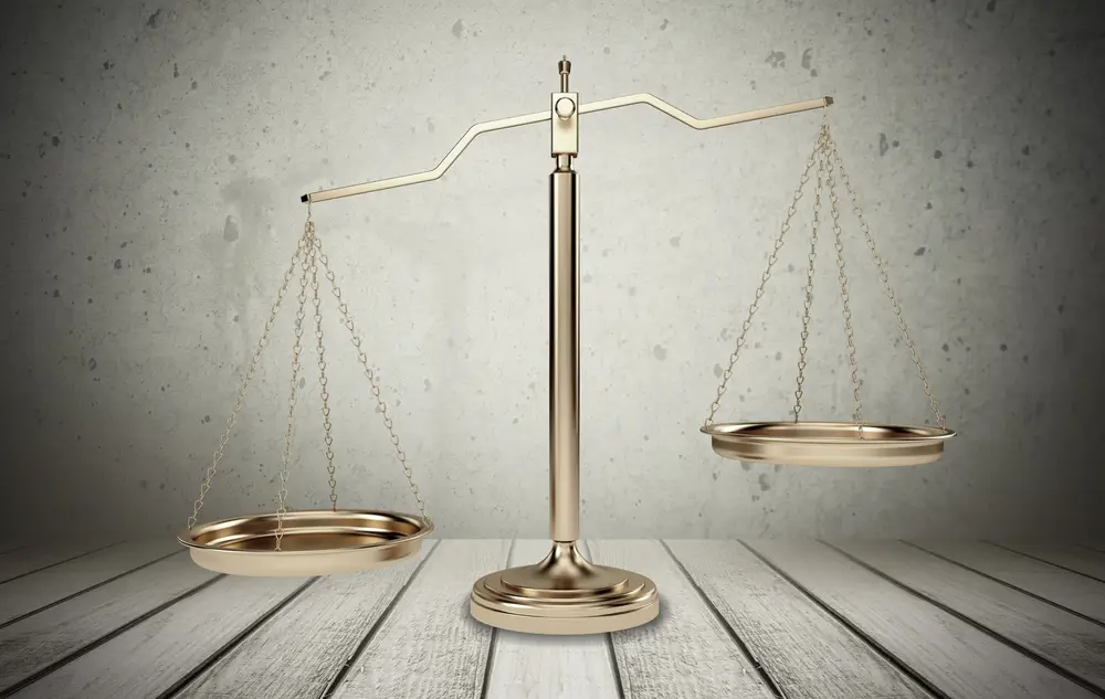 Balance de la justice dorée symbolisant l'objectivité et l'équité des critères d'évaluation des candidats.